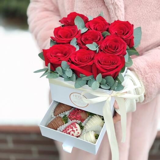 A small box with strawberries and red roses Romance