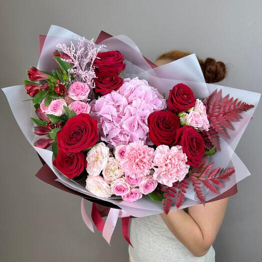 Bouquet of delicate flame of red roses and pink hydrangeas