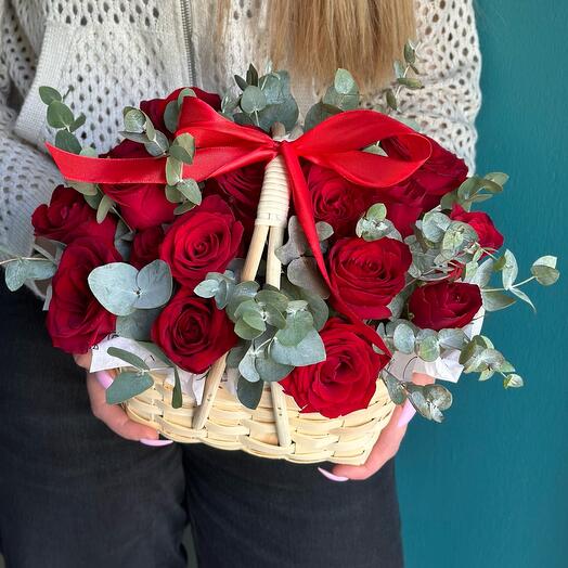 19 red roses in a basket with eucalyptus