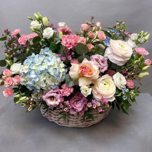 Basket with flowers of roses and hydrangeas