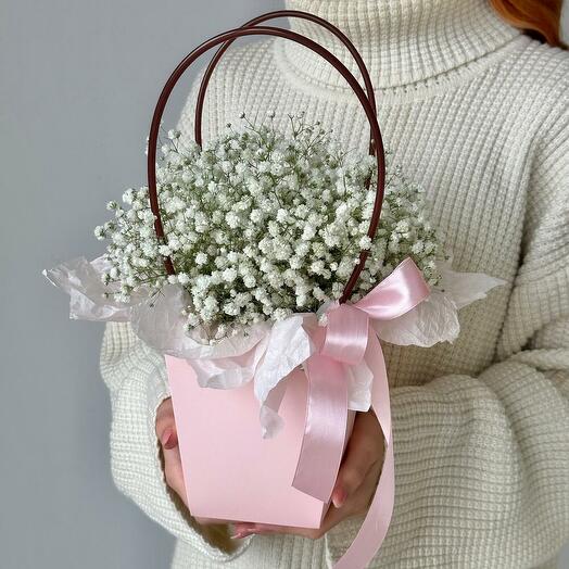 The composition of a white gypsophila in a handbag