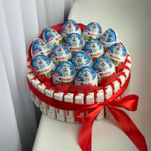 Kinder Surprise Egg and Kinder Chocolate Cake, a sweet gift set in a package with a bow for Easter