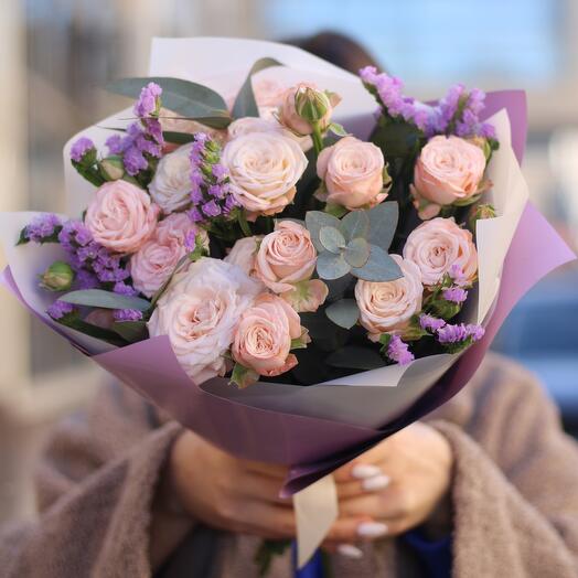 Bouquet of delicate peony-shaped roses with statice and eucalyptus twigs