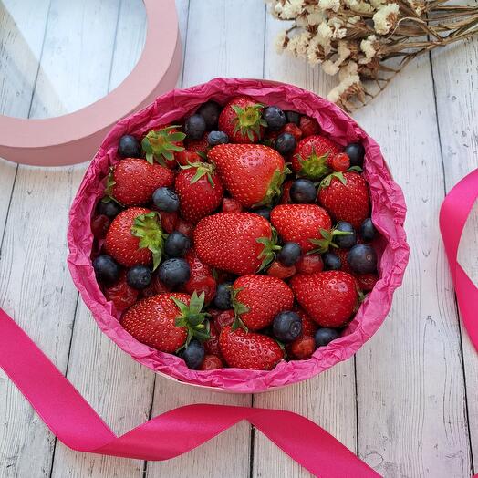 A box with strawberries and blueberries