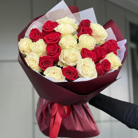 A loving look of 25 red and white roses in the design