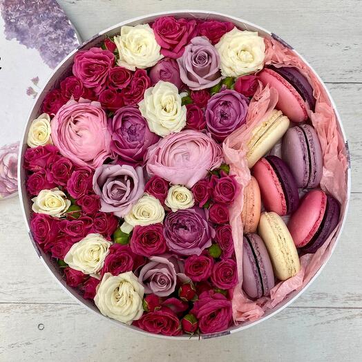 A box with flowers and macaroons is a bright day