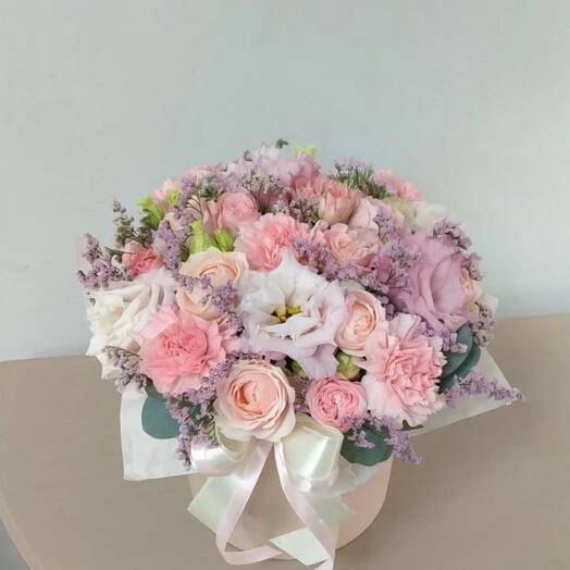 Bouquet of Ecuadorian bushy peony rose, limonium, pistache, dianthus in a hatbox