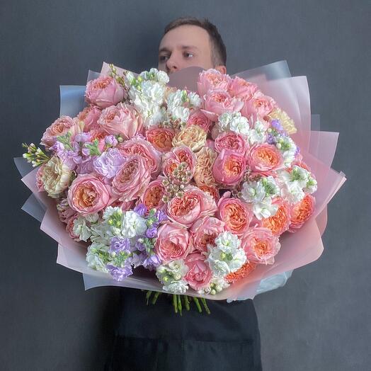 A large bouquet with peony-shaped bush roses Juliet , fragrant bush mattiola, carnations and chamelacium