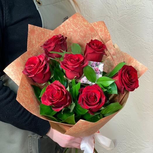 7 red roses with greenery