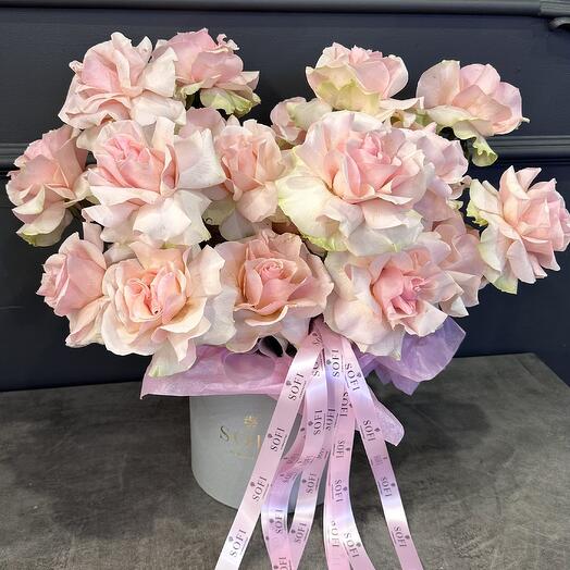 Delicate pink French roses in a box