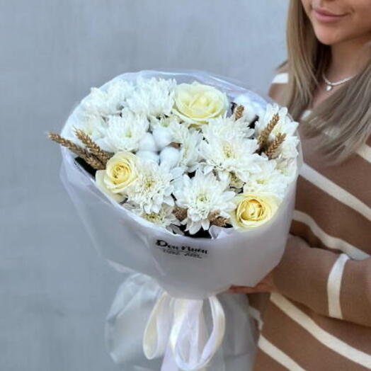 Delicate author's bouquet of chrysanthemums, roses and cotton with dried flowers