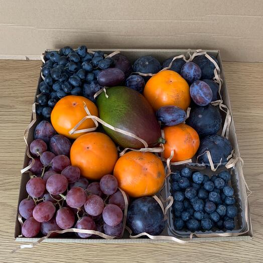 A gift of fruits. Fruit set of mango, persimmon, grapes, plums and blueberries