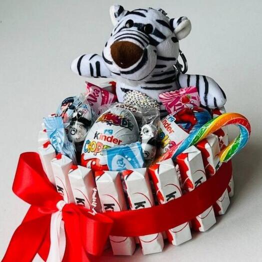 Sweet gift of kinder chocolate with a stuffed toy tiger Easter