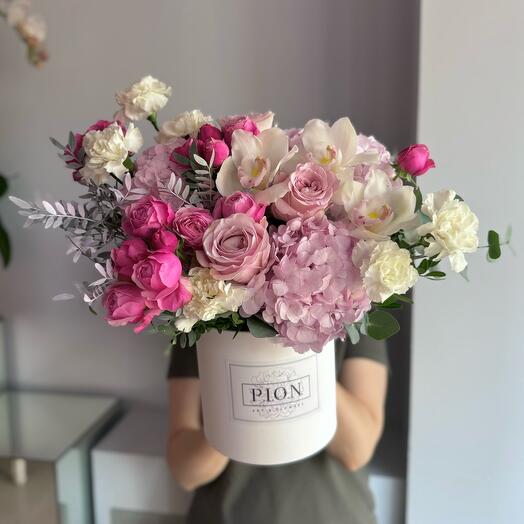 Flowers in a box with peony-shaped roses, cymbidium, pink hydrangeas