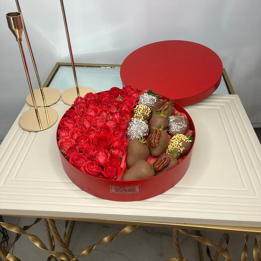 Красные розы и клубника в шоколаде в красной круглой коробке