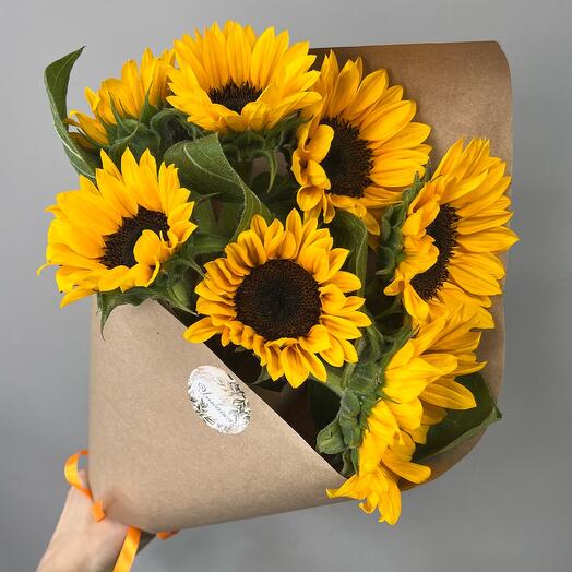A bunch of sunflowers in a bouquet of "7 wishes"