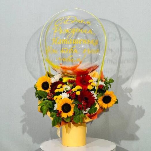 An original birthday gift is a bouquet of flowers with a sunflower and a bubble ball