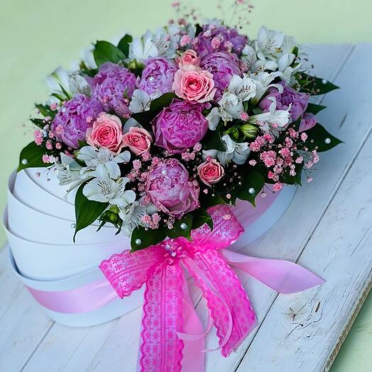 Cradle with flowers and peonies for the birth of a child and discharge from the hospital