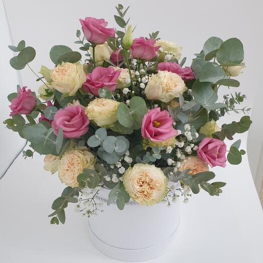 A hatbox arrangement of peony-shaped bush roses and lisianthus