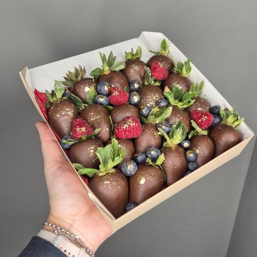 Chocolate-covered strawberries with raspberries and blueberries