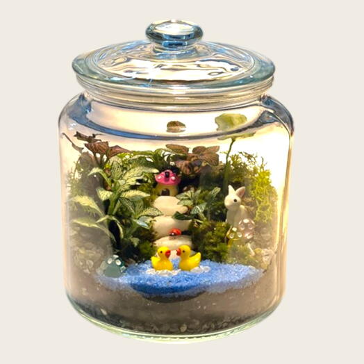 Lake and forest themed terrarium in a glass Jar