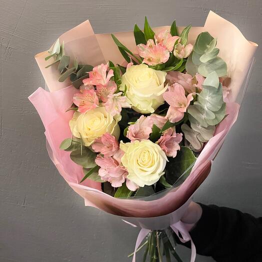 A beautiful bouquet of white roses, pink alstroemeria, and eucalyptus in a delicate design