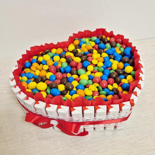 A heart of kinder chocolates with ememdems