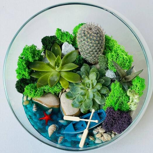 Outdoor florarium with fresh flowers and a boat in the sea
