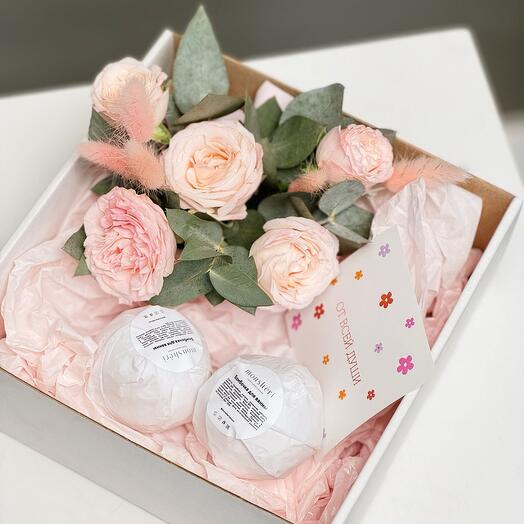 A gift set with handmade bath bombs and a floral arrangement