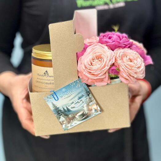 A set with a handmade scented candle and a composition in a coffee cup