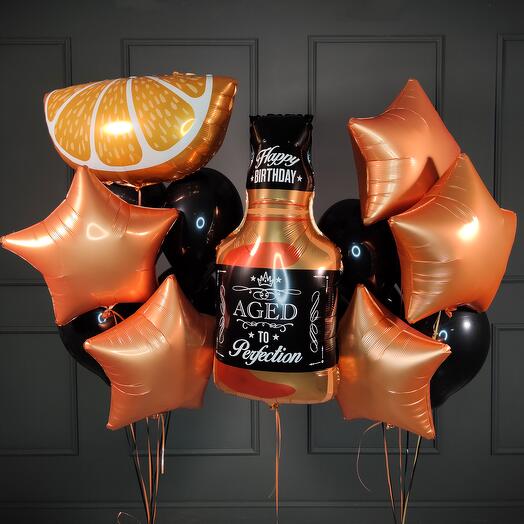 Composition of balls with a bottle of whiskey and a slice