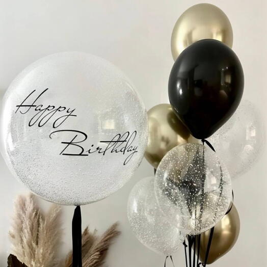 A large balloon with an inscription (any one), balls with confetti, gold, black balls in the fountain