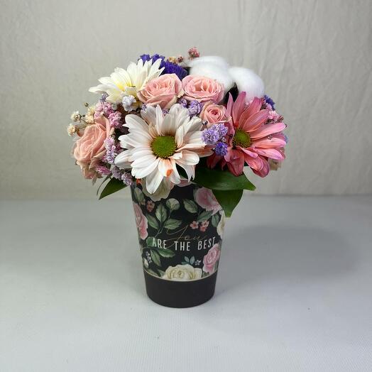 A glass with a rose and a chrysanthemum