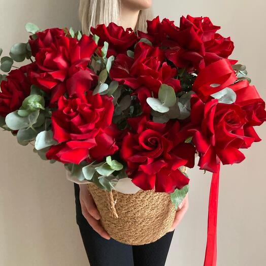 French roses in a basket with eucalyptus