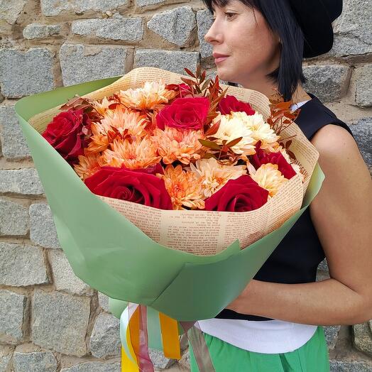 A bright bouquet with red roses, peach bush chrysanthemum and greenery