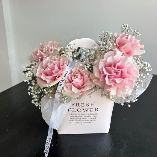 Roses and gypsophila in a handbag