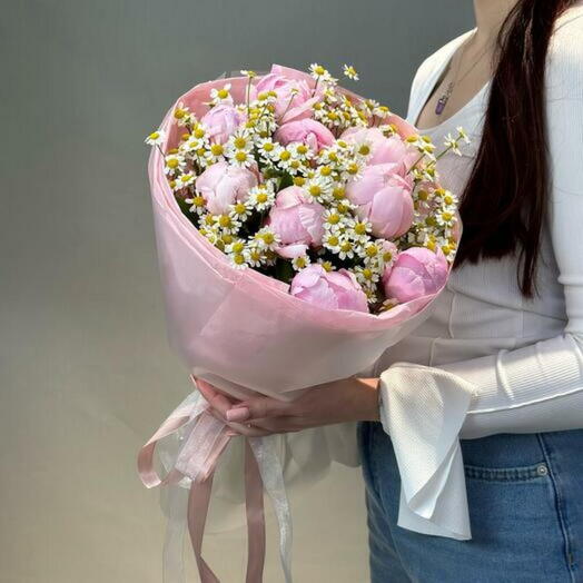 Delicate bouquet of peonies and chamomiles