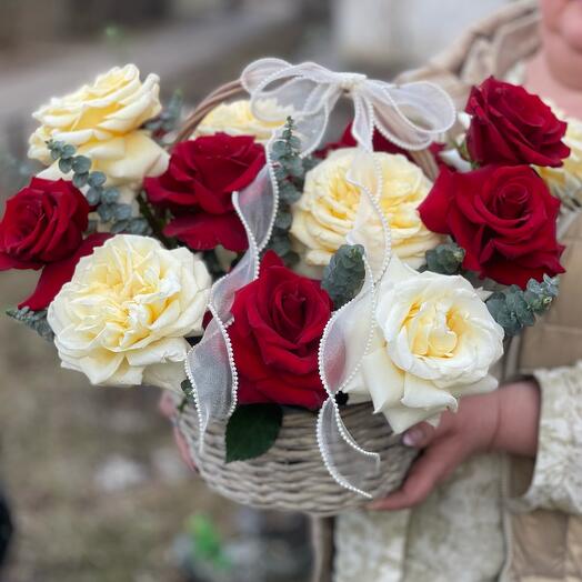 Basket with fragrant French roses and eucalyptus