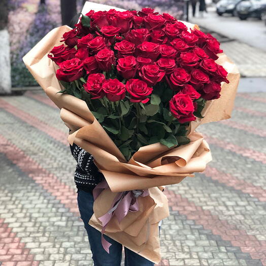 Love with 50:50 Long stems of red roses in a brown wrapping