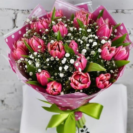Bouquet of 21 pink tulips with gypsophila in a package