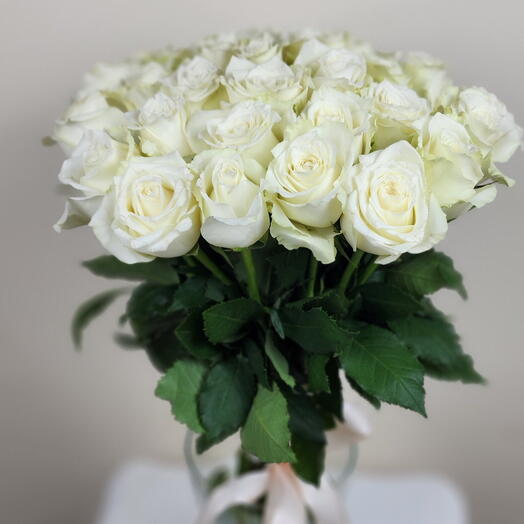 35 white roses in a vase