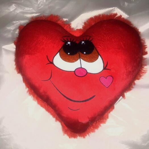 Almohada corazón con una sonrisa