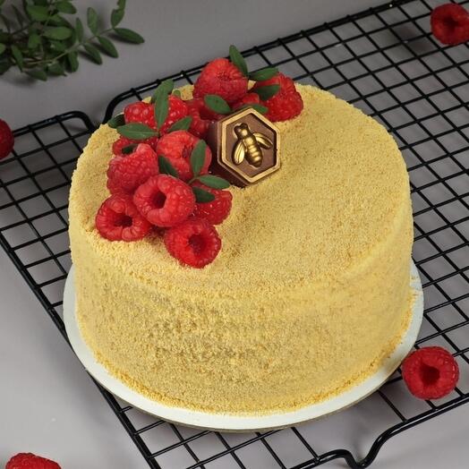 Honey cake with sour cream decorated with raspberries