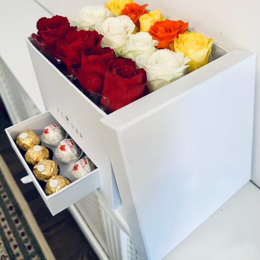 Flowers in a white box with chocolates
