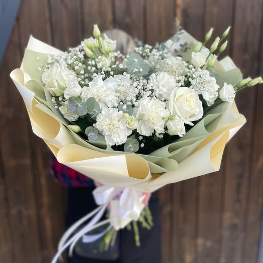The bouquet is light with peony-shaped roses and gypsophila