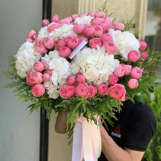 Bouquet of bush peony-shaped roses and vegetation