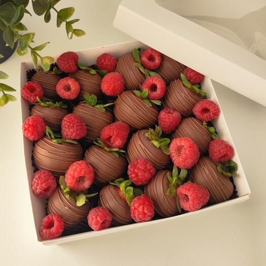 Strawberries in milk chocolate with raspberries