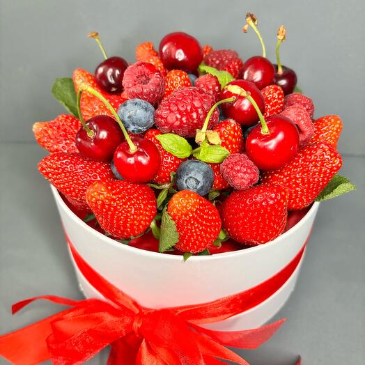Strawberries, raspberries, blueberries in a hatbox. The berry box. Fresh strawberries in a hatbox. Box size S