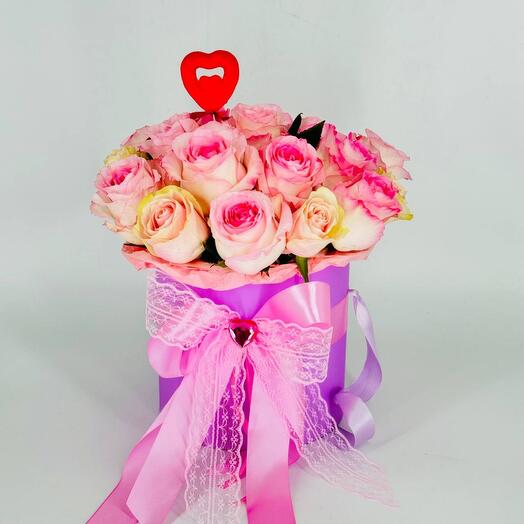 Bouquet of pink roses in a hatbox with a heart topper