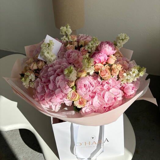 A bouquet of hydrangeas and a peony-shaped rose